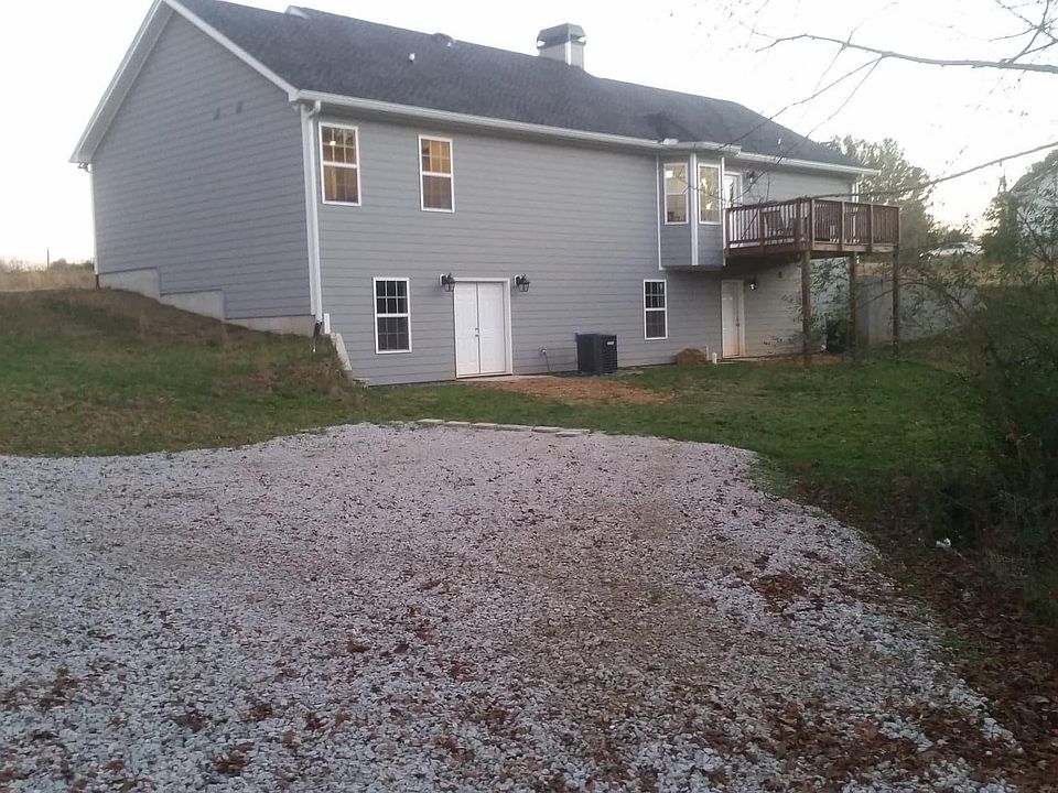 Tenant parking and entrance into basement. Spacious backyard.