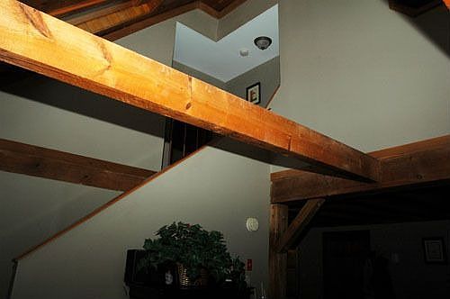 exposed beams and vaulted ceilings in living room
