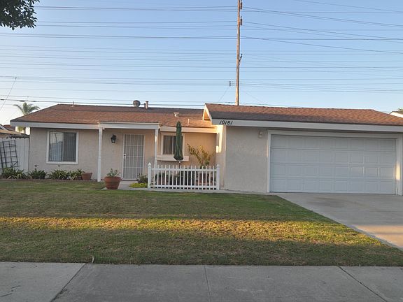 Front view of single-family house showing Attached double-car Garage with Washer and Dryer hook-ups.