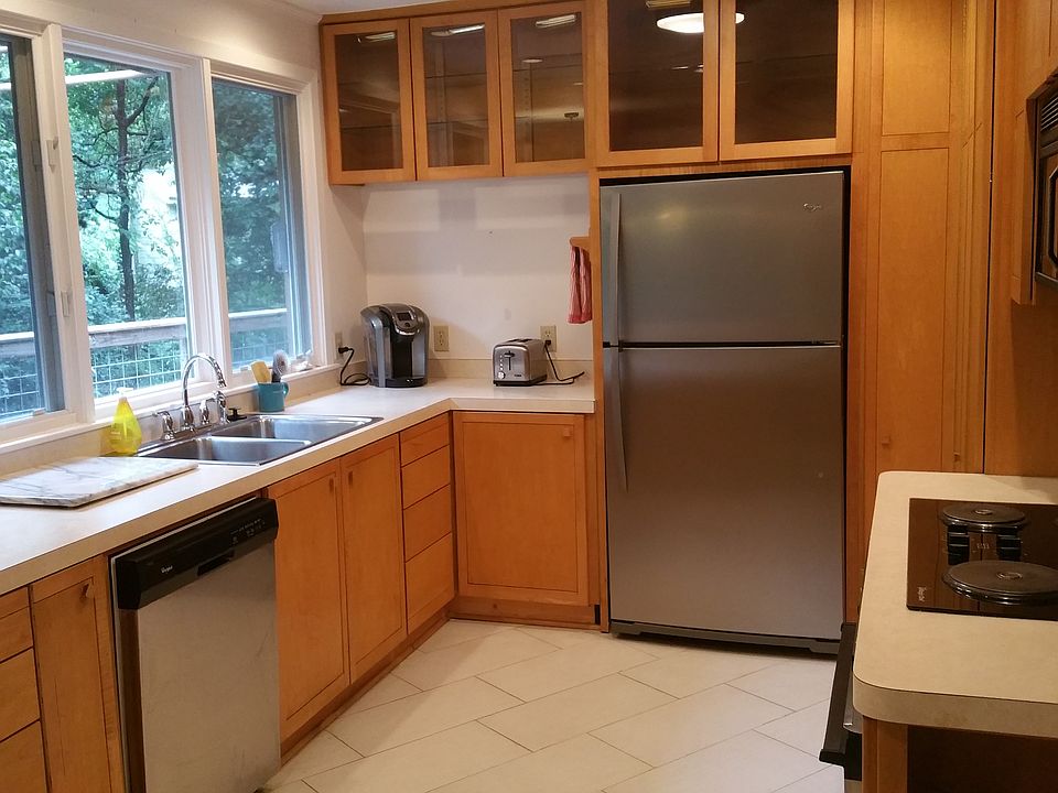 Large windows over sink to take in the view of wet weather c