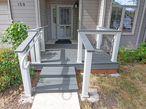 Large front porch accommodates a bench for sitting. Shaded by a large Raywood ash in the afternoons.
