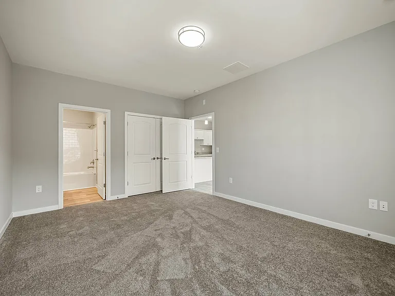 Experience tranquility in this bright and spacious bedroom featuring seamless room transitions.