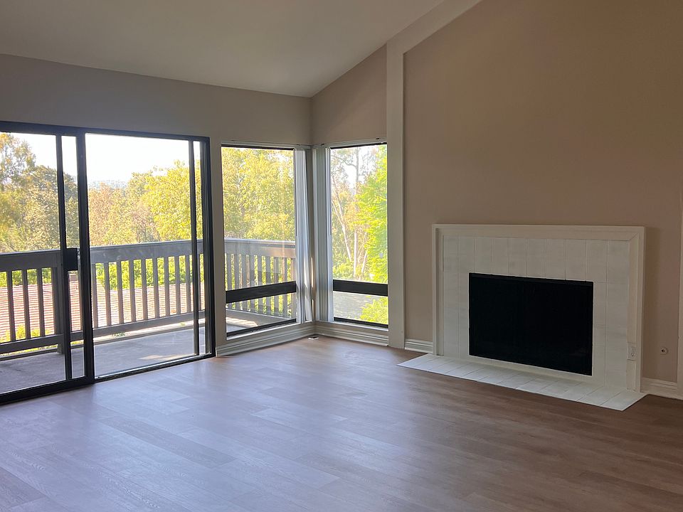 Living room with gas fireplace, sliding glass doors leading to large view deck.