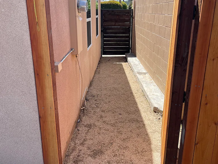 Private side walkway with direct access to backyard and trash area.