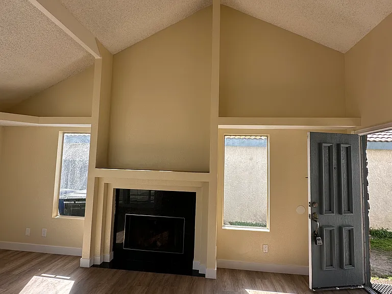 Living room high ceiling with fire place.