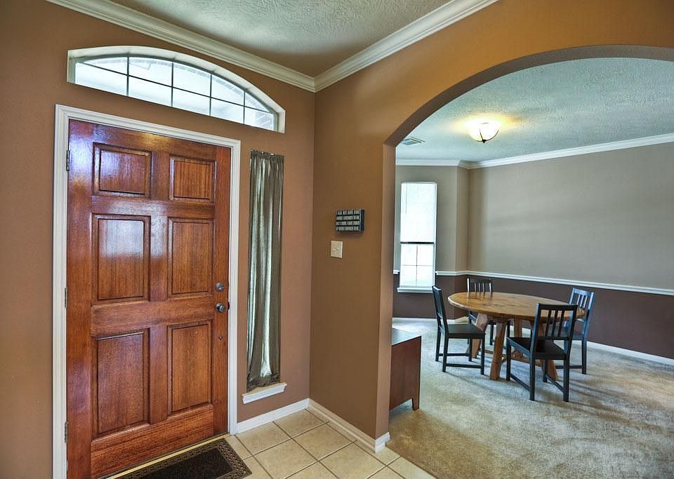 Formal Dining room to the left of entry; 1/2 bath and laundry to the right.