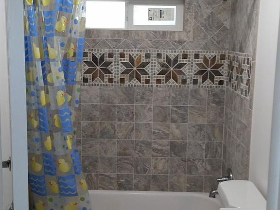 Bathroom. There is a floor to ceiling corner storage cabinet