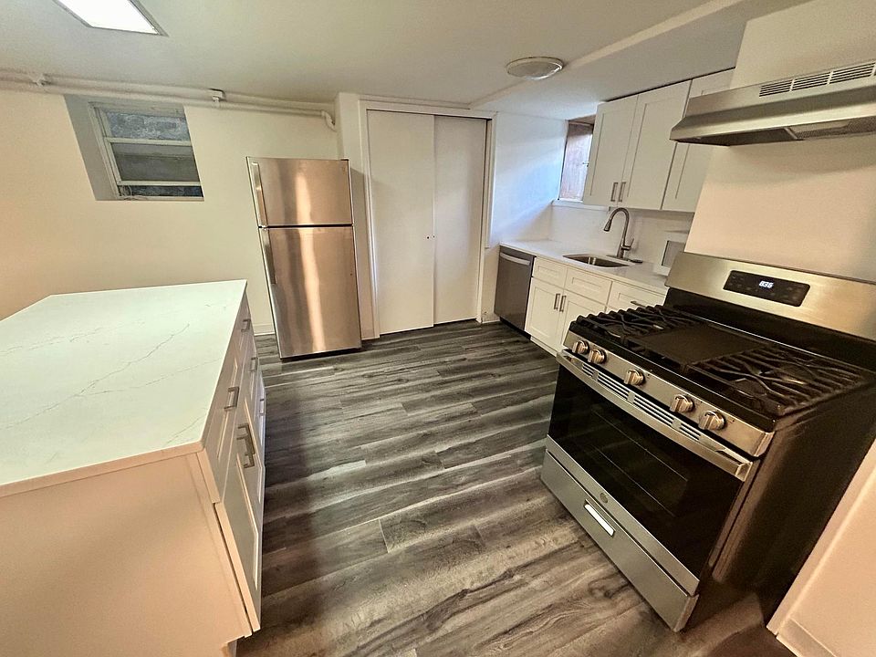 Kitchen was recently fully renovated w/ white shaker cabinets, quartz countertop & island, D/W, SS appliances