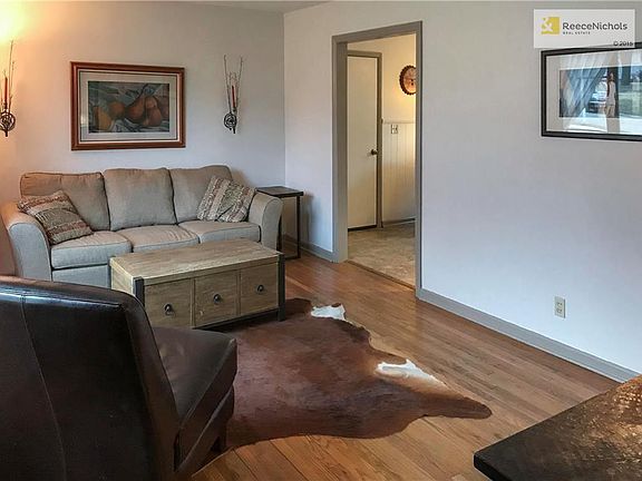 living room with hardwood floors and leads into the kitchen.