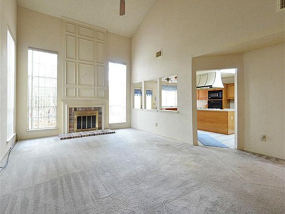 Huge two-story den features gas fireplace.