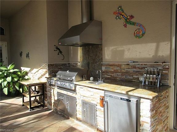 Stainless steel summer kitchen grill in the courtyard