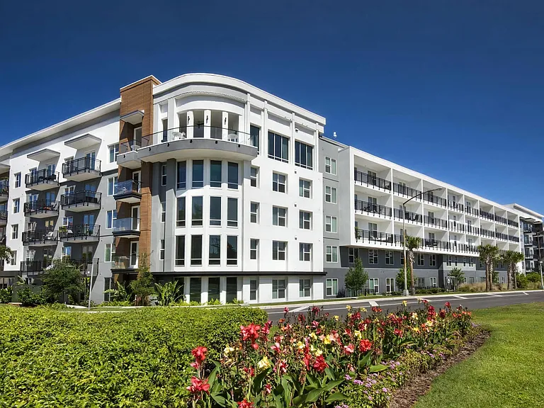 Anchor Riverwalk Apartment Community with Landscaped Grounds and Corner Window Design