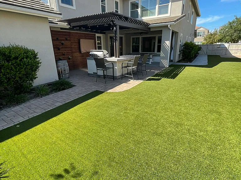 Low Maintenance backyard with Pavers and Turf.