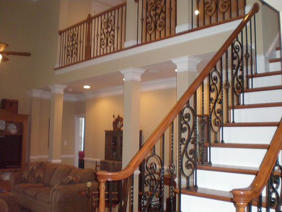 Stunning 2 story entry way with rod iron ballisters leading upstairs. 