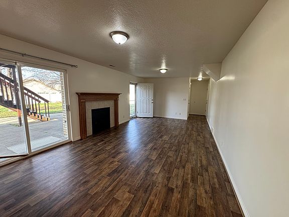 Large living area with lovely fireplace and dining area. Coat closet in the hall.