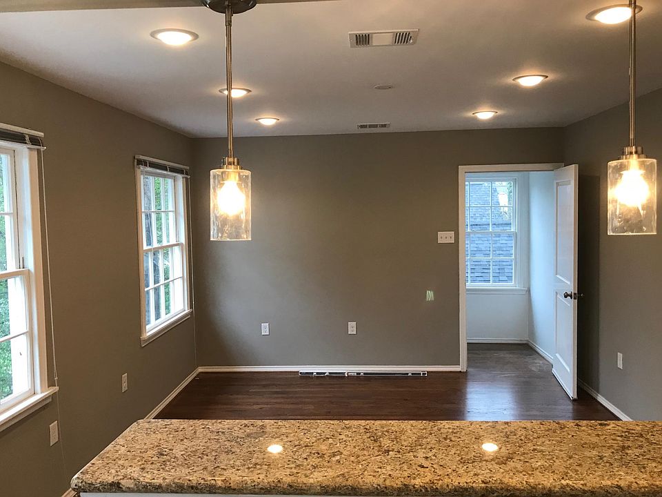 Bar counter with pendant lights overlooking living room