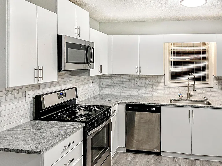 updated kitchen with new microwave and fridge