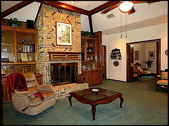 Beautiful masonry fireplace is surrounded with built ins to display your treasures.