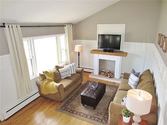 The Living Room has Cathedral Ceilings, Hardwood Floors and a Big Picture Window! Built Disply Fireplace for Looks, Pretty Nice Feel!