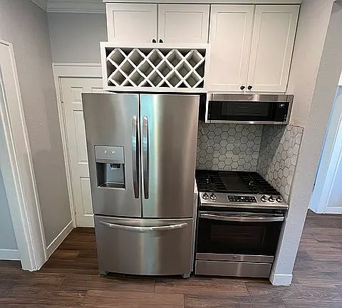 new stainless appliances and wine rack