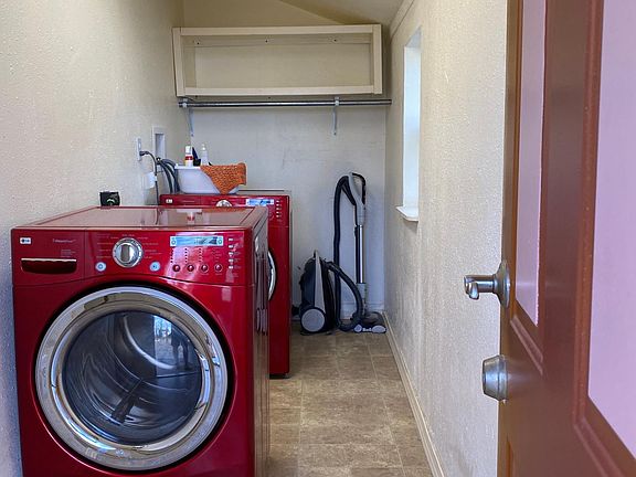 Separate room for laundry with front loader washer and dryer. Vacuum provided.