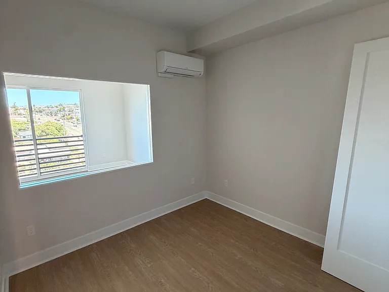 Bedroom, blinds to be installed on glass window looking out to the main living space.