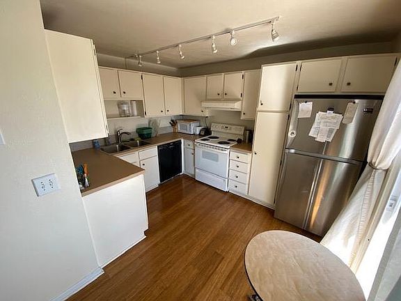 Kitchen with stainless steel fridge, dishwasher and range
