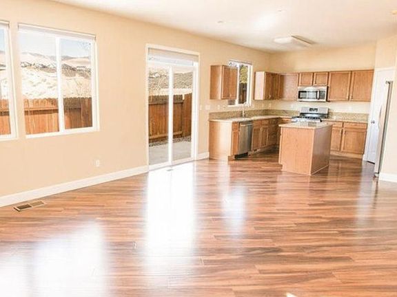 Open floor plan off of kitchen. Plenty of room for your living room furniture. Access to back yard off of kitchen.