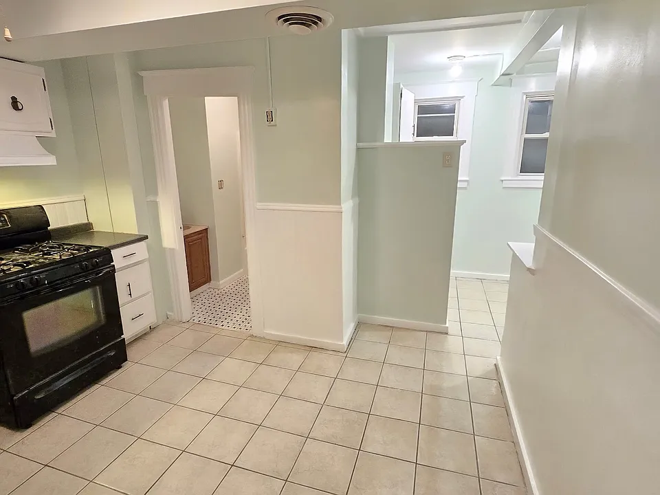 Kitchen off living room with back nook and bath.