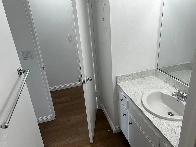 Master bath vanity leading to hallway door