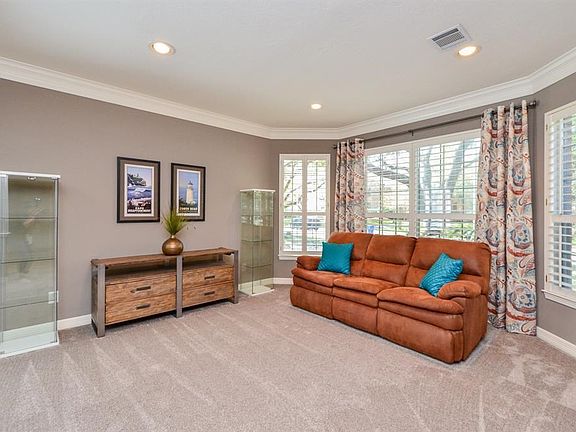 Formal living room with pretty plantation shutters. The bayed window adds character. New carpeting & paint. Recessed lights and pretty molding create a warm room. Perfect for entertaining.