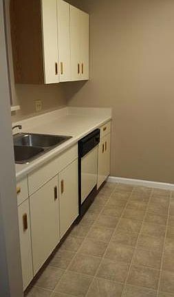 Spacious galley kitchen with range, refrigerator, dishwasher