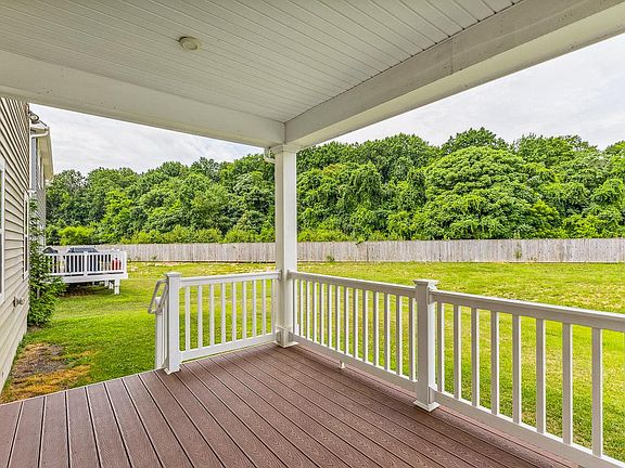 Enjoy the summer grilling, entertaining, and enjoying your covered back deck, spacious yard, overlooking the woods