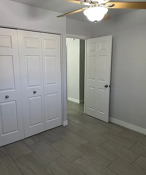 Second Floor Third (3) Bedroom, Brand New Tile and Grout, New Baseboard Molding, New Curtains, Ceiling Fan with Light, Large Wall Closet with New Hardware.