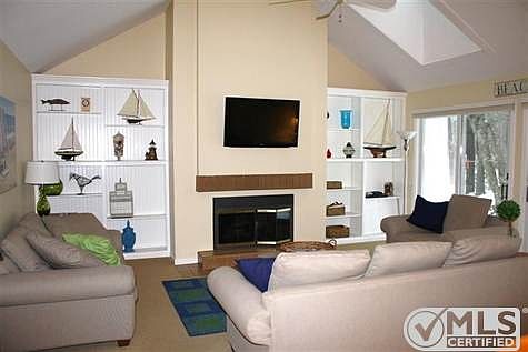 Lovely living room with gas fireplace, new doors to pretty stone patio.