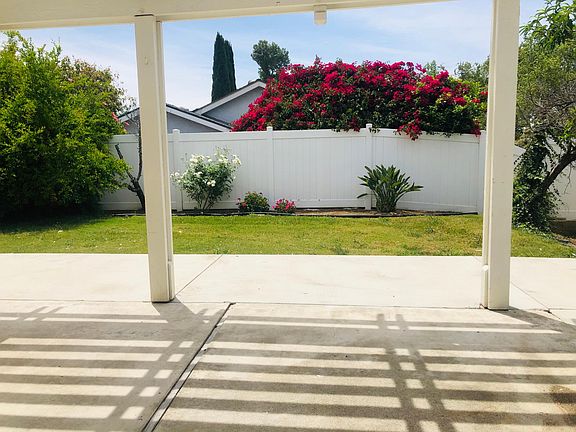 View of backyard underneath backyard trellis