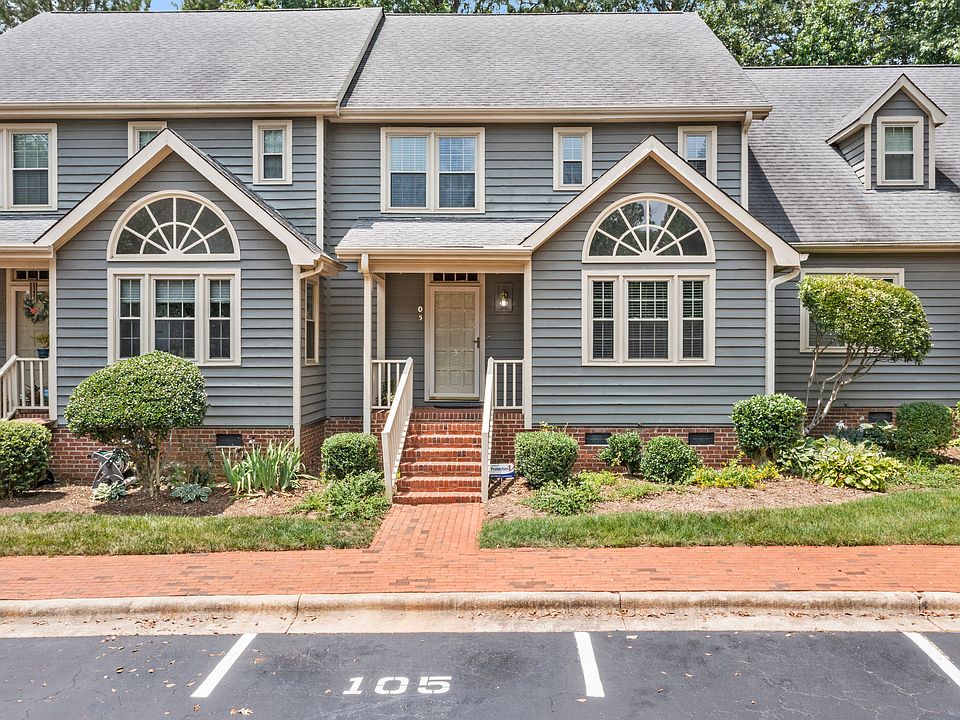 Welcome to 105 Pebble Loch, a charming townhome with classic curb appeal and a brick-lined entry.