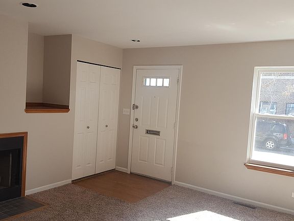 Living room with lots of natural lighting and fireplace.