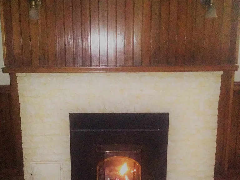 Natural Gas Fireplace with Natural Wood, Valance Lights, and Tile Floor