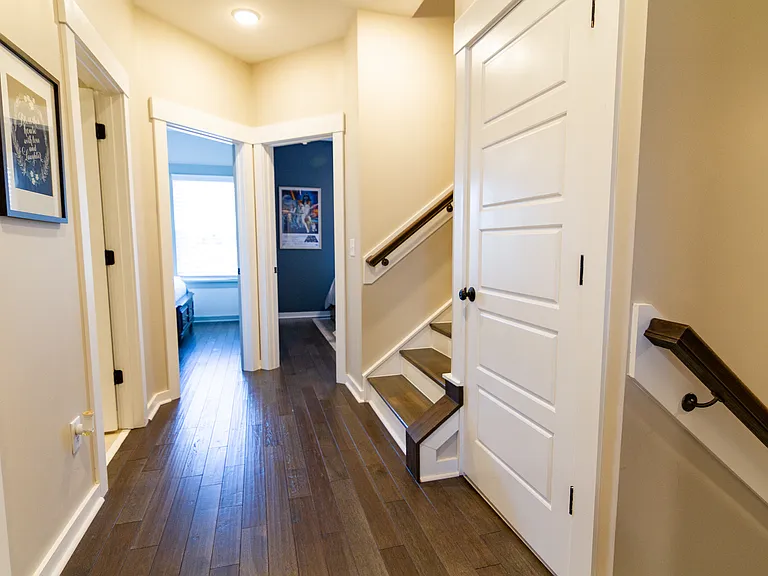 Hallway on the second floor with stackable washer and dryer and large linen closet.