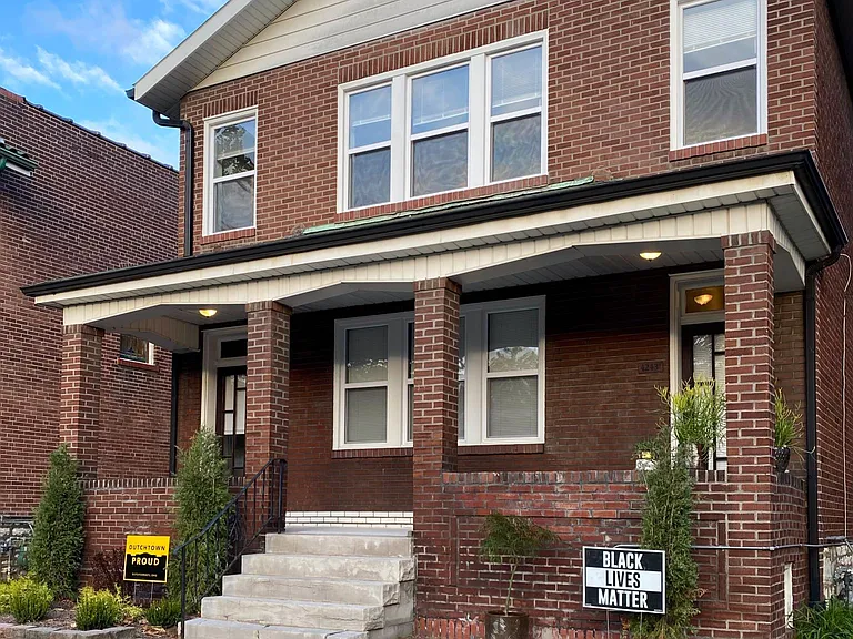 Street view, first floor unit enters through left hand door.