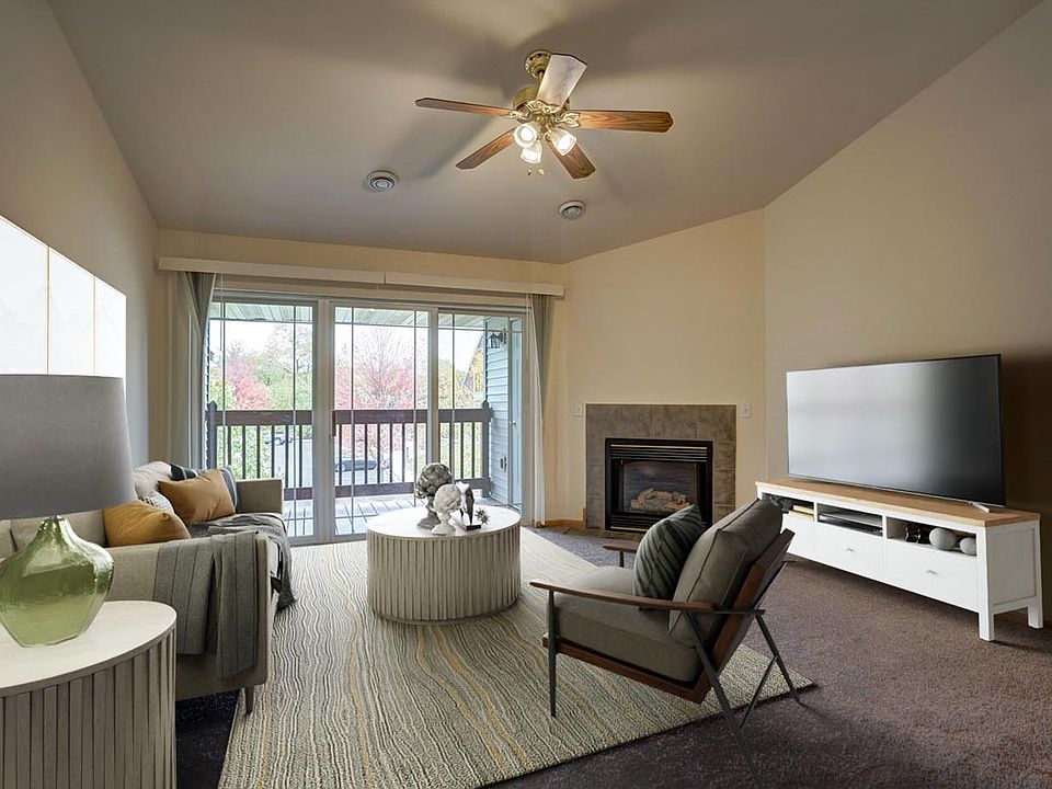 Similar unit; virtually staged. Living room. Available unit does not have vaulted ceilings