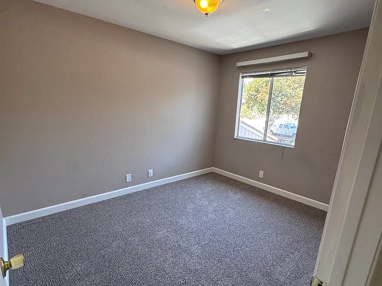3rd Bedroom with small walk-in closet (not shown) and wall heater.