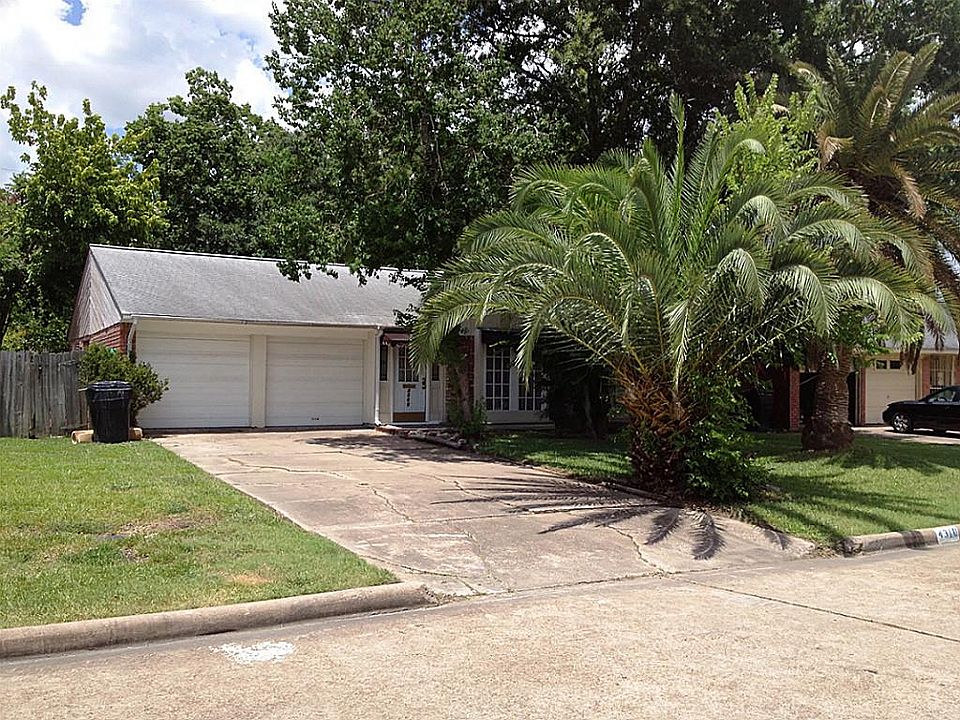 This beautiful home has plenty of shade from these mature trees.