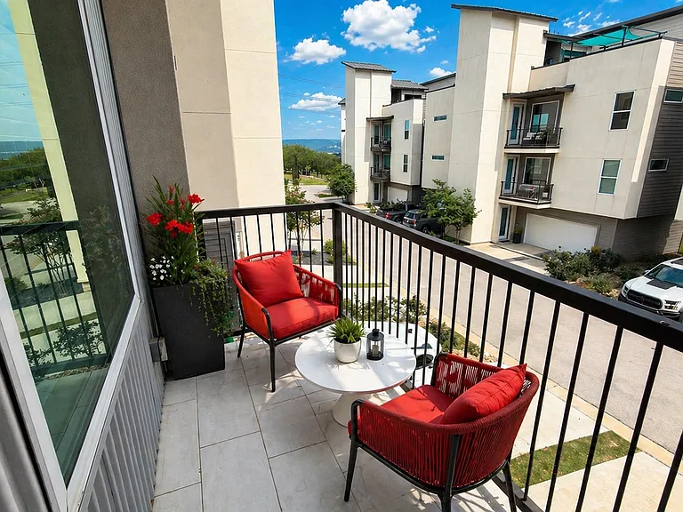 Imagine starting your day with a cup of coffee on this beautiful balcony, taking in peekaboo views of Lake Travis. :)
