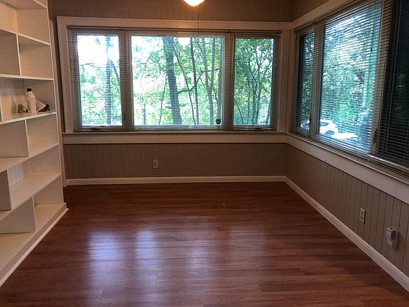 Living area with built in book shelves. Windows look out to the front, Stacy Park is just across the street.