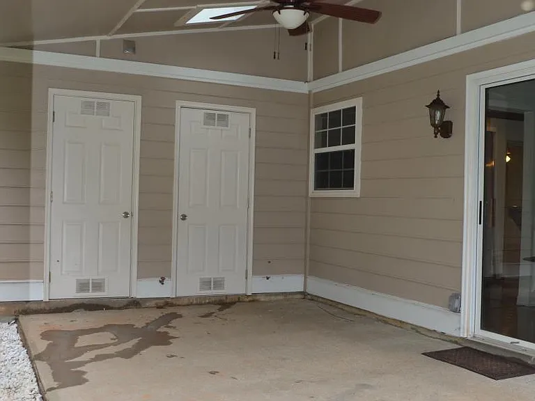 Back patio - skylights, ceiling fan. Looking onto privacy-fenced yard.