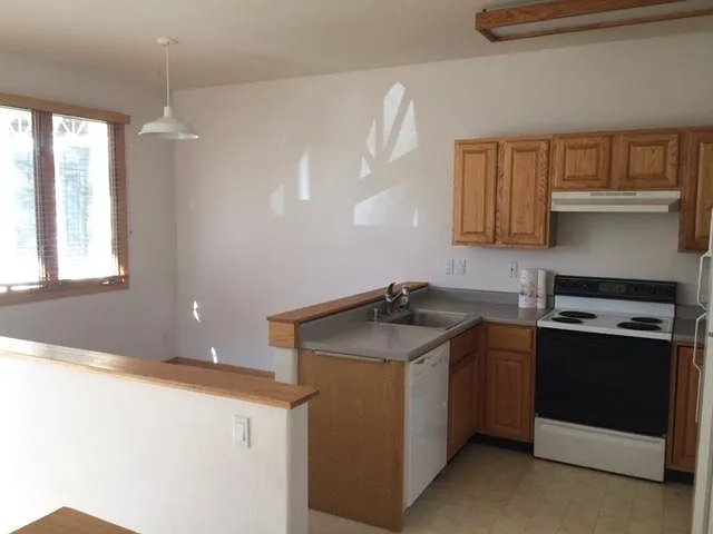 Kitchen/Dining. Picture shows old appliances that have since been replaced with new stainless steel appliances including over range microwave.
