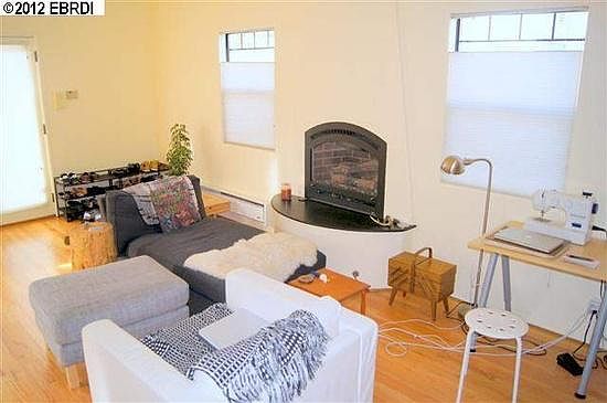 Downstairs living room with gas fireplace. Entry doorway at far left