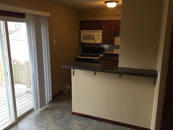 updated kitchen with gas range and refrigerator with icemake
